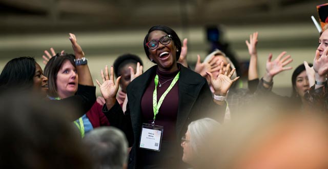 NCTE convention attendee celebrating Hands Raised Joyful