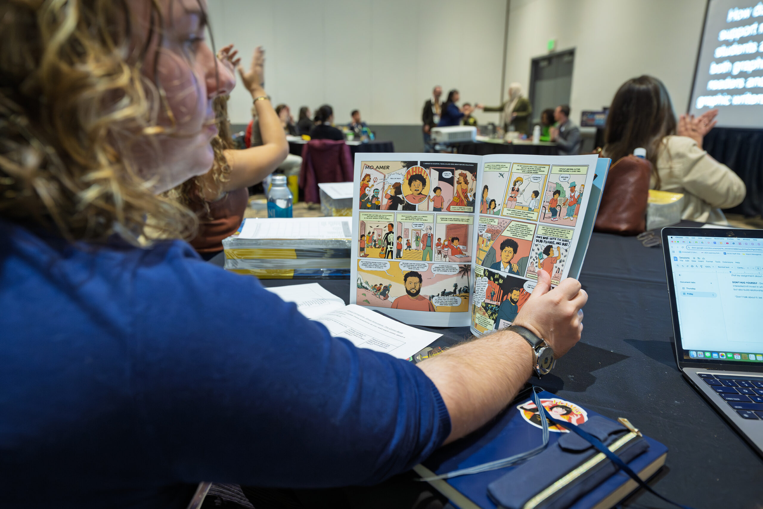NCTE convention attendee reading Graphic Novel